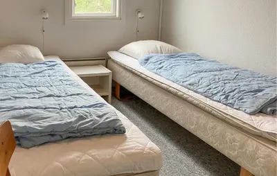 two beds sitting next to each other in a room at Pet Friendly Home In Vestervig With Sauna in Vestervig