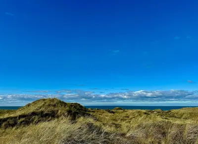 a view of the ocean from the beach at Bright Holiday Home Close To Sea Near Blokhus in Blokhus