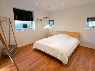 a bedroom with a bed and two windows at 4 star holiday home in Hanstholm in Hanstholm