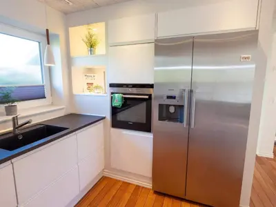 a kitchen with a stainless steel refrigerator and a sink at 4 star holiday home in Hanstholm in Hanstholm