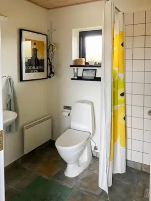 a bathroom with a toilet and a sink at Summerhouse By The Heath Near The North Sea in Snedsted