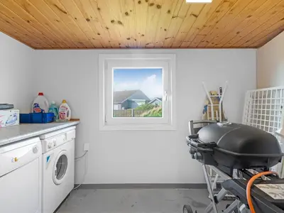 a laundry room with a washing machine and a window at Holiday Home Gisa - 500m from the sea by Interhome in Thisted