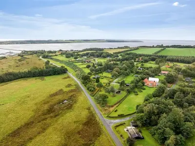 an aerial view of a field with a house and a road at Holiday Home Velika - 300m to the fjord by Interhome in Roslev