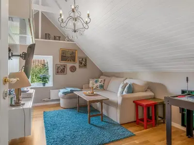 a living room with a couch and a table at Holiday Home Missa - 2km to the fjord by Interhome in Ejerslev