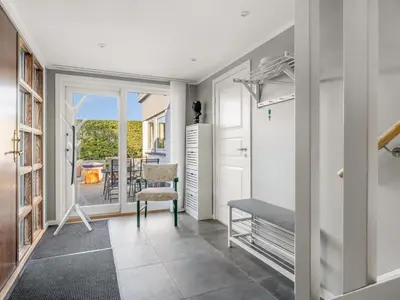 a room with a hallway with a table and a chair at Holiday Home Missa - 2km to the fjord by Interhome in Ejerslev
