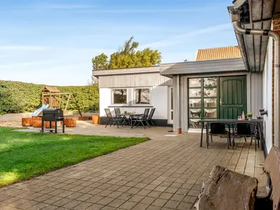 a patio with a table and a grill at Holiday Home Missa - 2km to the fjord by Interhome in Ejerslev