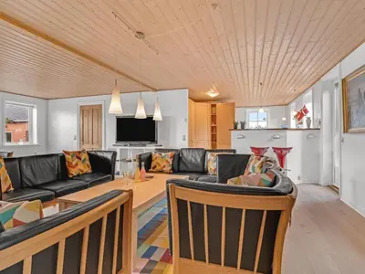 a living room with a couch and a table at Holiday Home Nette - 2km to the fjord by Interhome in Thyholm