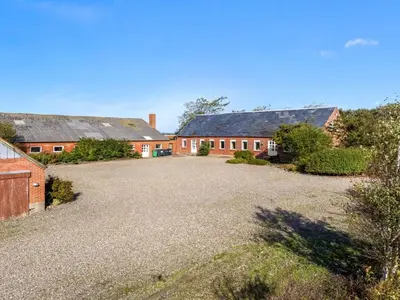 an empty driveway in front of two brick buildings at Holiday Home Nette - 2km to the fjord by Interhome in Thyholm