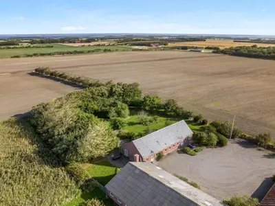 an aerial view of an old barn and a field at Holiday Home Nette - 2km to the fjord by Interhome in Thyholm