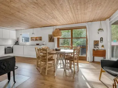 a kitchen and dining room with a table and chairs at Holiday Home Ingamaj - 4km from the sea by Interhome in Brovst