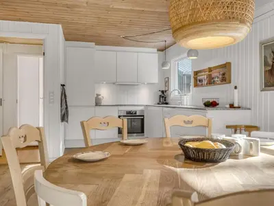 a kitchen and dining room with a table and chairs at Holiday Home Ingamaj - 4km from the sea by Interhome in Brovst