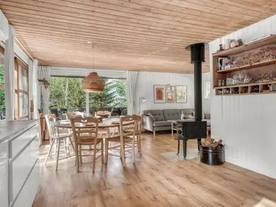 a kitchen and living room with a table and chairs at Holiday Home Ingamaj - 4km from the sea by Interhome in Brovst