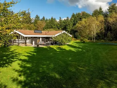 a house with a large yard with green grass at Holiday Home Inola - 3-5km from the sea by Interhome in Fjerritslev