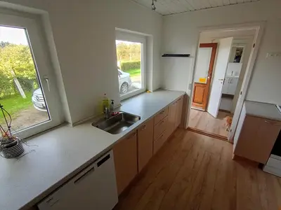 an empty kitchen with a sink and a window at Apartment with water views in Fjerritslev