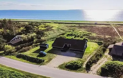 an aerial view of a house next to the ocean at Cozy Home In Løgstør With Sauna in Løgstør