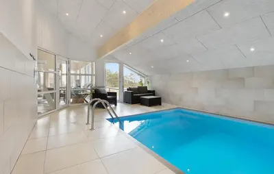 a swimming pool in a house with a living room at Cozy Home In Løgstør With Sauna in Løgstør