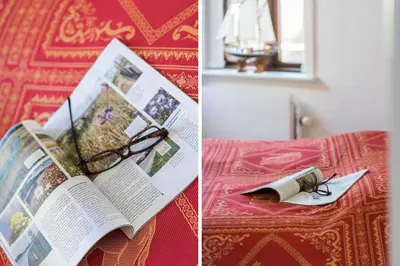a book and a pair of glasses sitting on a bed at 719-Thyboron-Fanovej-3 in Thyborøn