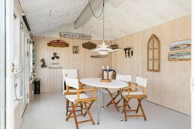 a dining room with a white table and chairs at 719-Thyboron-Fanovej-3 in Thyborøn