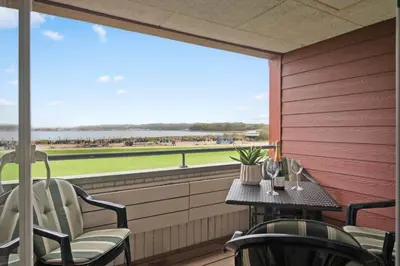 a balcony with a table and chairs and a view of the beach at G186-Lemvig-Vinkelhagevej-186 in Lemvig