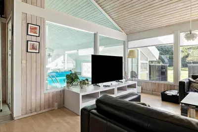 a living room with a couch and a flat screen tv at BL1129-Saltum-Ornebjergvej-6 in Saltum
