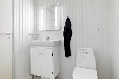 a white bathroom with a sink and a toilet at BL1129-Saltum-Ornebjergvej-6 in Saltum