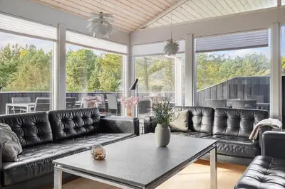 a living room with leather couches and a table at BL1129-Saltum-Ornebjergvej-6 in Saltum