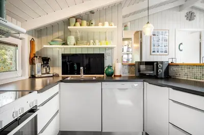 a kitchen with white cabinets and a sink at 1334-Thisted-Ingerslevvej-14 in Thisted