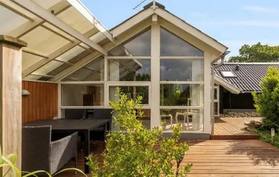 a conservatory with a table and chairs on a deck at Amazing Home In Spøttrup With House A Panoramic View in Spottrup