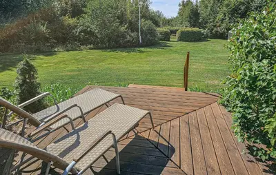 a wooden deck with two chairs and a table at Amazing Home In Spøttrup With House A Panoramic View in Spottrup