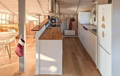 a kitchen with white cabinets and a wooden floor at Amazing Home In Spøttrup With House A Panoramic View in Spottrup