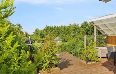 a backyard with a deck with plants at Amazing Home In Spøttrup With House A Panoramic View in Spottrup