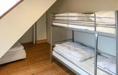 two bunk beds in a room with a staircase at 4 Bedroom Beach Front Home In Vinderup in Vinderup