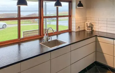 a kitchen with a sink and two windows at 4 Bedroom Beach Front Home In Vinderup in Vinderup