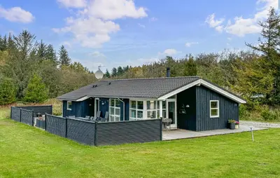 a small green house with a deck in a field at Lovely Home In Fjerritslev With Wifi in Fjerritslev