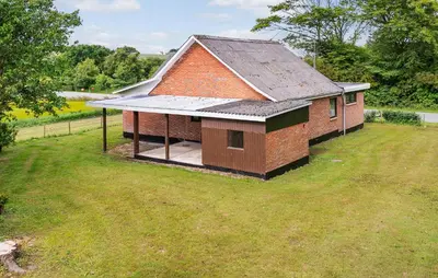 a small brick house in a field of grass at 1 Bedroom Nice Home In Hurup Thy in Ullerup