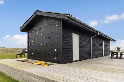 a building with a climbing wall on a deck at 820-Harboore-Bjergehusvej-19 in Harboør