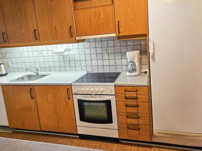 a kitchen with a white stove top oven next to a refrigerator at 6 person holiday home in Lemvig in Lemvig
