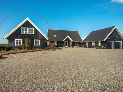 a house with a red hose on a gravel driveway at 4 star holiday home in Ranum in Ranum