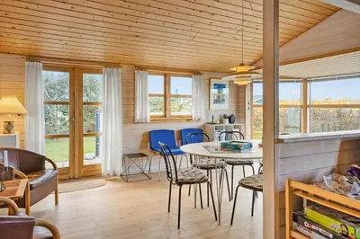 a kitchen and living room with a table and chairs at 1069-Thisted-Kobbelsti-23 in Thisted