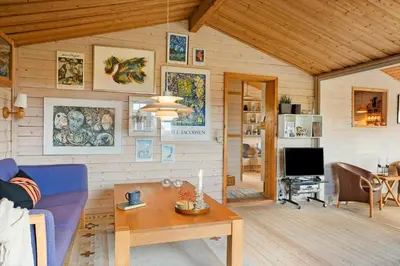 a living room with a blue couch and a table at 1069-Thisted-Kobbelsti-23 in Thisted