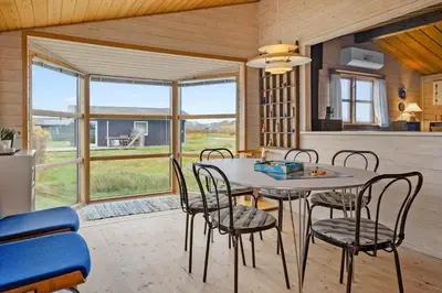 a kitchen and dining room with a table and chairs at 1069-Thisted-Kobbelsti-23 in Thisted