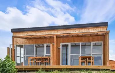 a wooden house with a lot of windows at 5 Bedroom Amazing Home In Hanstholm in Hanstholm