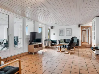 a living room with a couch and a tv at 4 star holiday home in Harboøre in Harboør