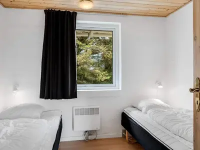 a bedroom with two beds and a window at 4 star holiday home in Harboøre in Harboør