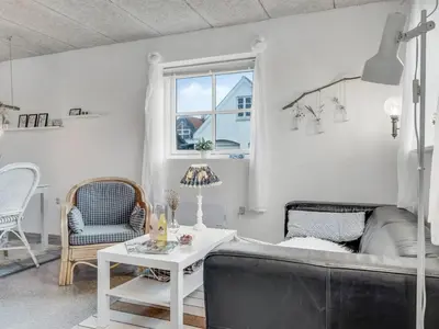 a living room with a couch and a table at Holiday Home Sylvana - 75m from the sea by Interhome in Thisted