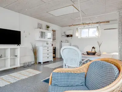 a living room with a table and chairs at Holiday Home Sylvana - 75m from the sea by Interhome in Thisted