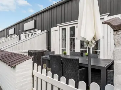 a patio with an umbrella and a table and chairs at Apartment Epiphania - 100m to the fjord by Interhome in Vestervig