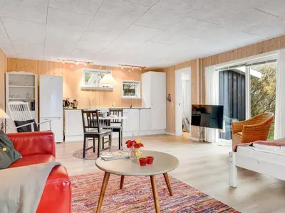a living room with a couch and a table at Holiday Home Tekla - 75m from the sea by Interhome in Thisted