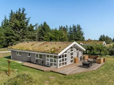 a tiny house with a grass roof at Holiday Home Melita - 2km from the sea by Interhome in Blokhus
