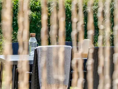 a table with a bottle of water on it at Holiday Home Melita - 2km from the sea by Interhome in Blokhus
